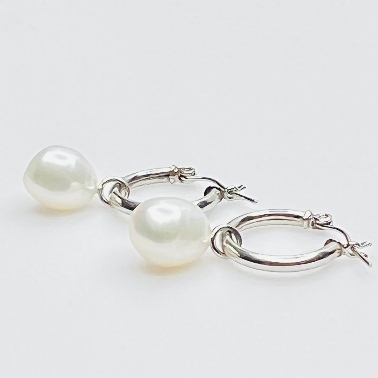 Side view of sterling hoop with removable pearl drop