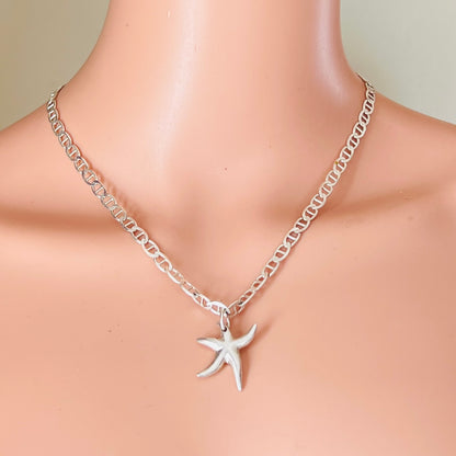 Starfish pendant necklace worn on mannequin silver nautical chain