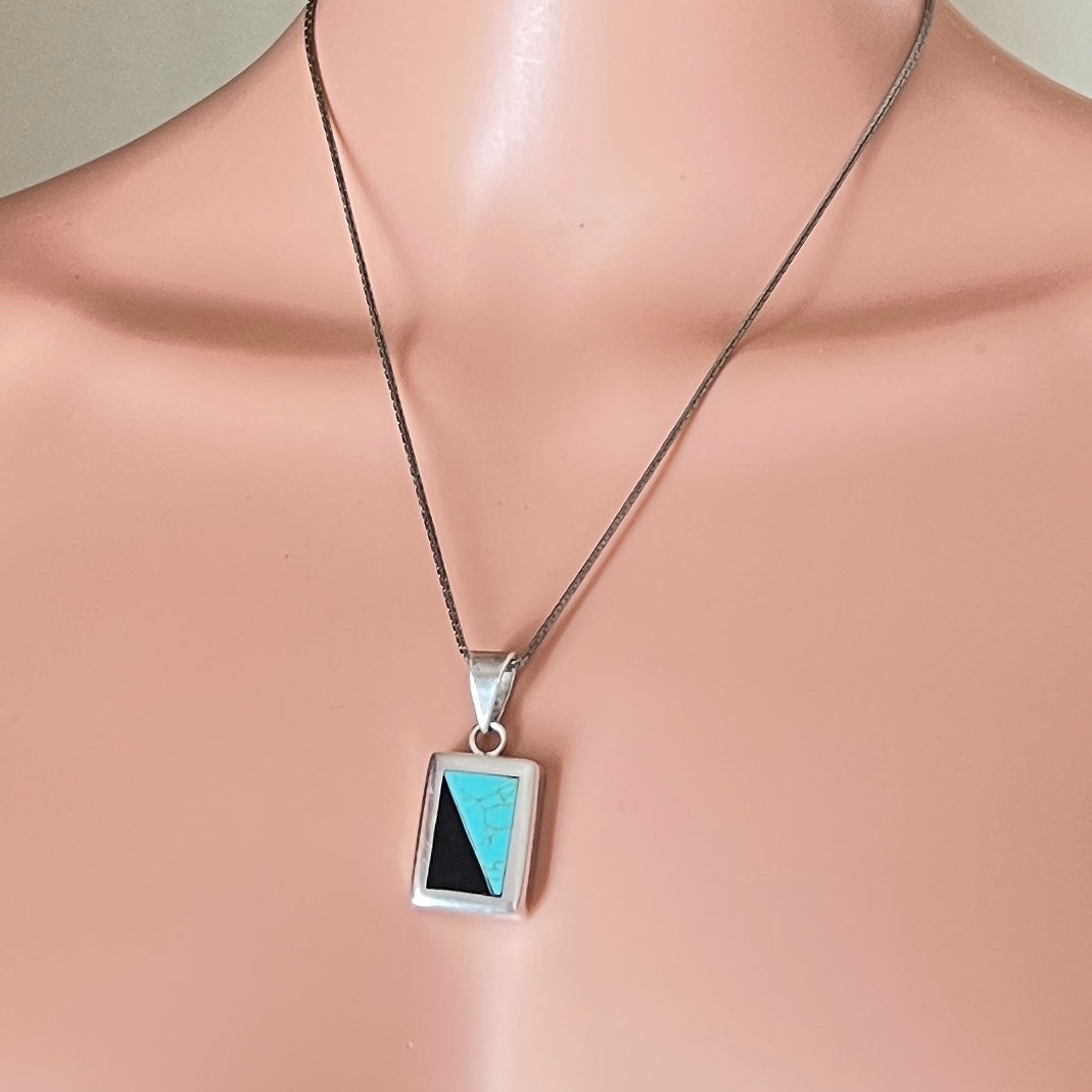 Turquoise and onyx inlay sterling pendant necklace on mannequin