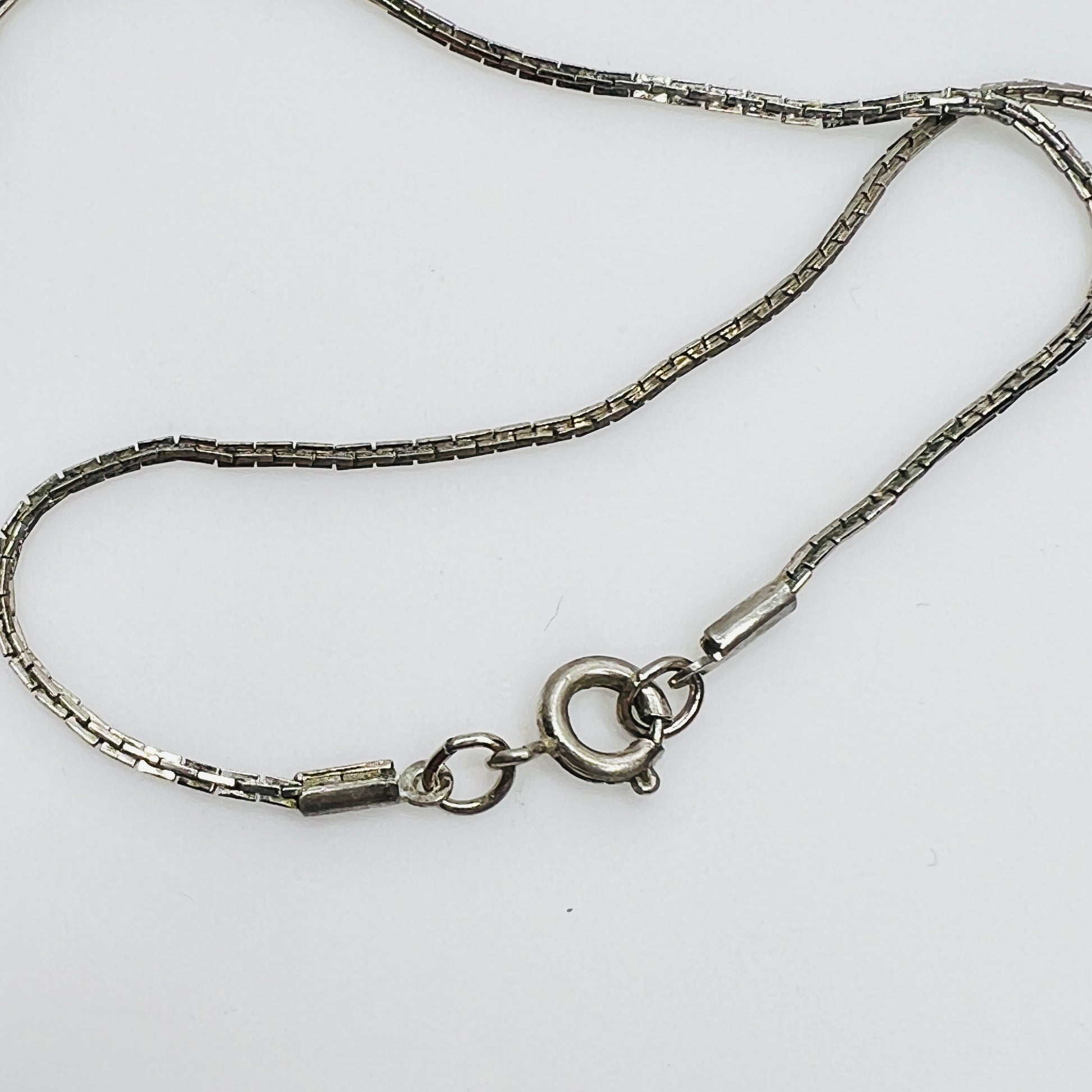 Close-up of spring ring clasp on non-sterling box chain
