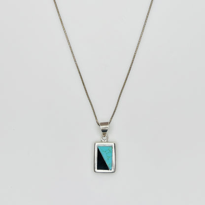 Detail of sterling pendant with turquoise and black onyx inlay