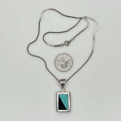 Full view of geometric inlay pendant on chain