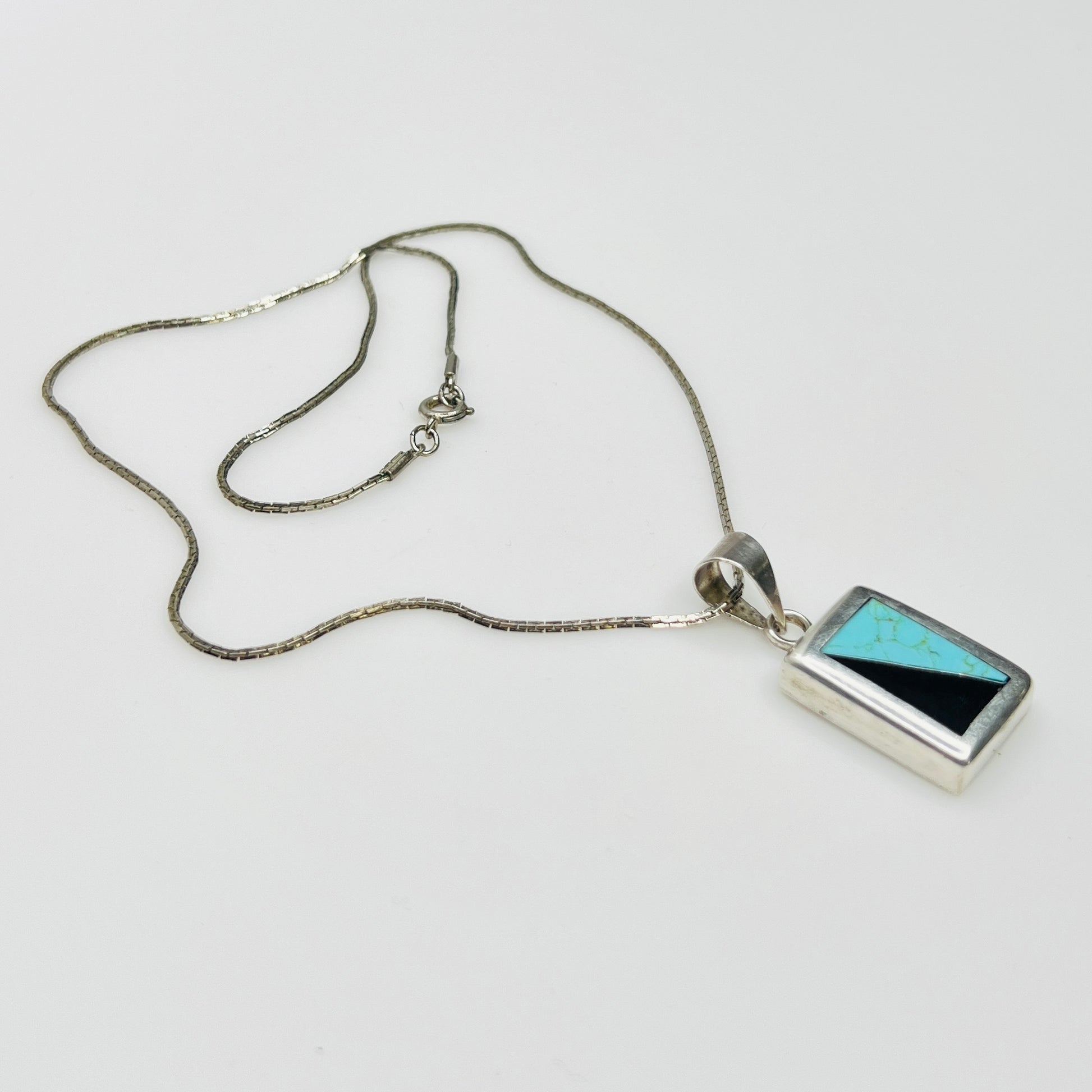 Full view of geometric inlay pendant on chain