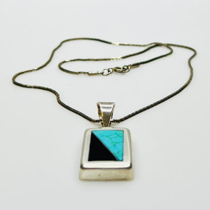 Full view of geometric inlay pendant on chain