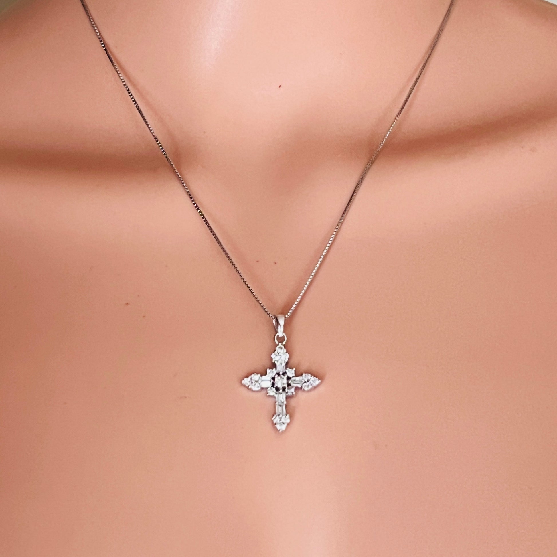 Sterling silver CZ cross necklace worn on mannequin