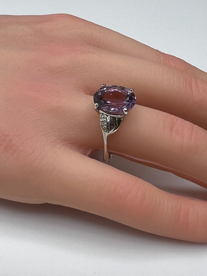 Vintage sterling silver ring with oval purple amethyst and diamond accents