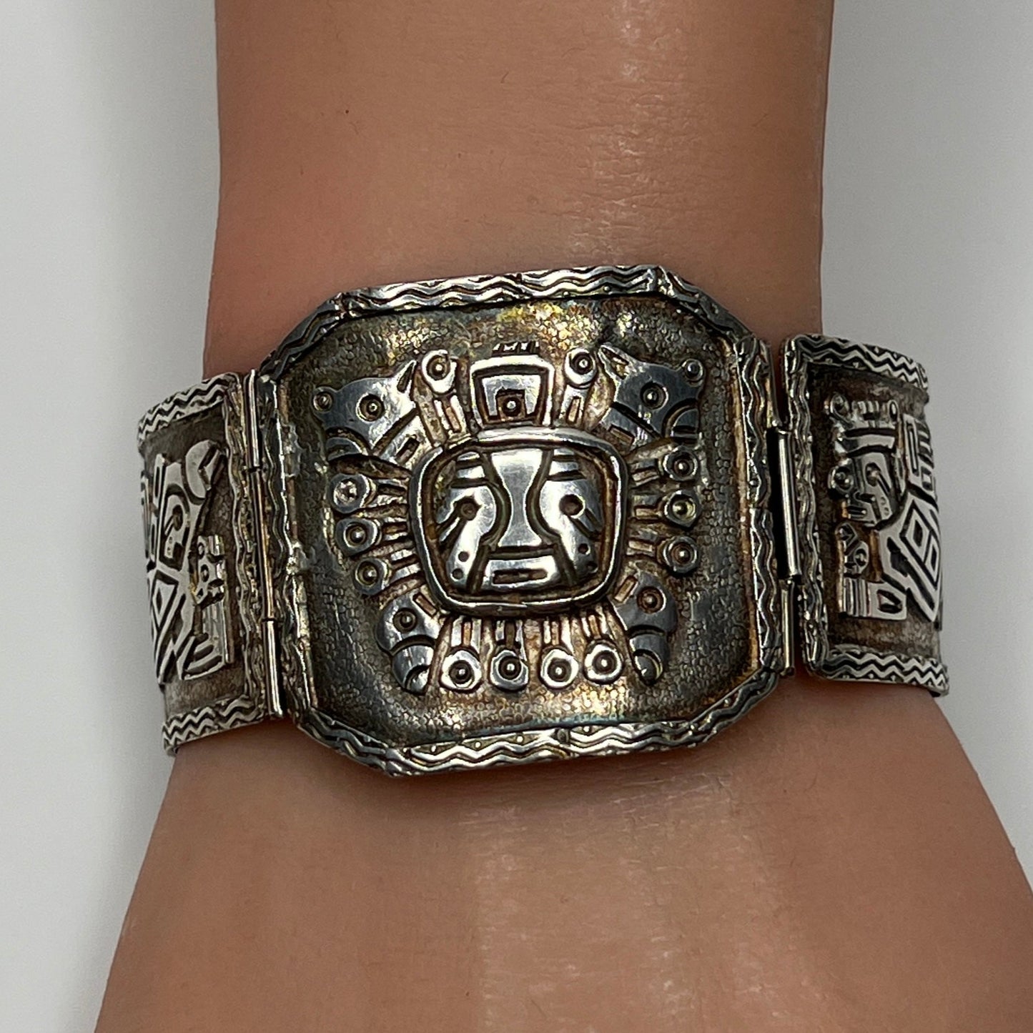 Close-up of center panel with sun deity motif and oxidized detailing