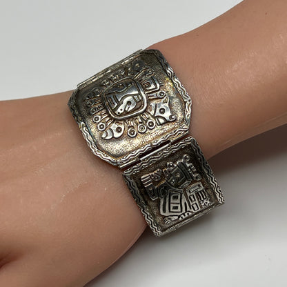 Side view of bracelet panels featuring etched ancient warrior and animal symbols