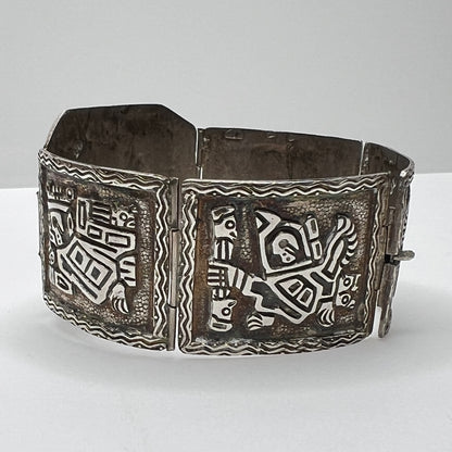 Side view of bracelet panels featuring etched ancient warrior and animal symbols