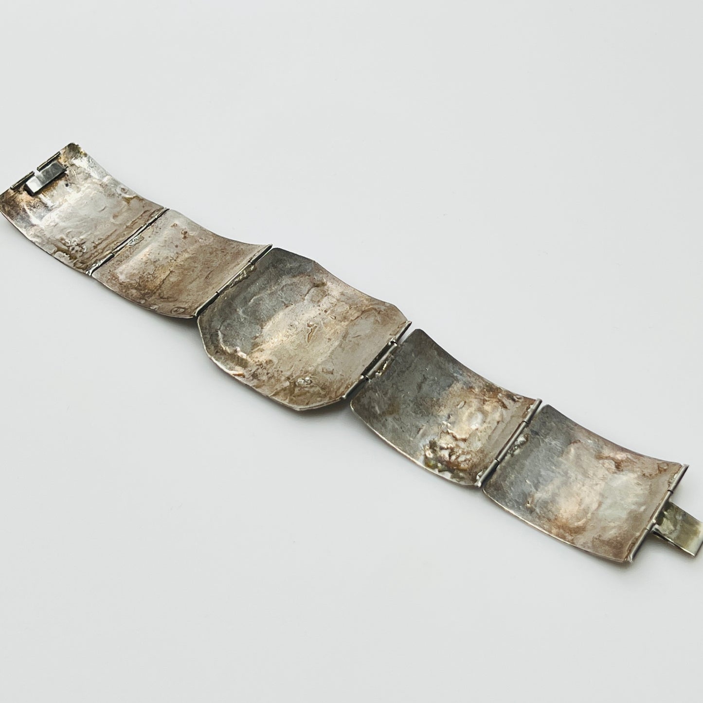 Underside of bracelet showing hand-hammered texture and partial silver marks