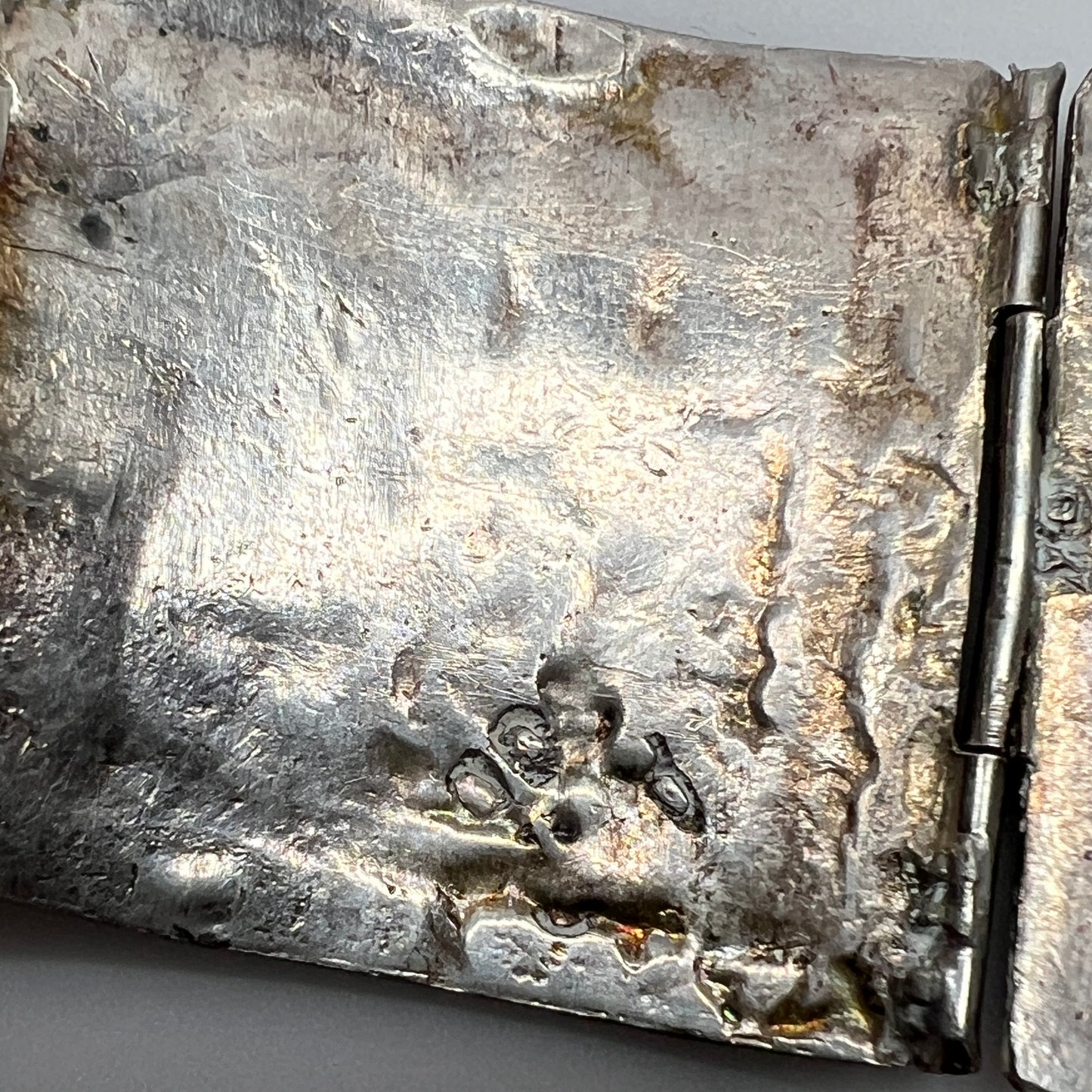 Underside of bracelet showing hand-hammered texture and partial silver marks