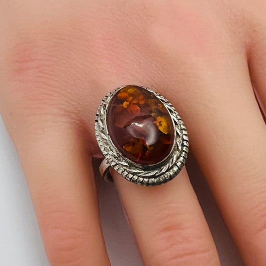 Sterling silver ring with oval amber cabochon and rope bezel