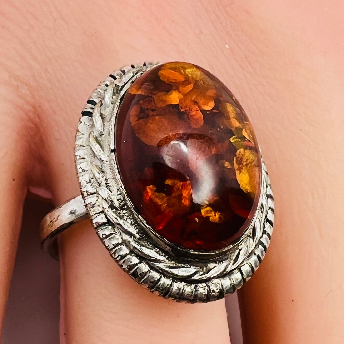 Sterling silver ring with oval amber cabochon and rope bezel