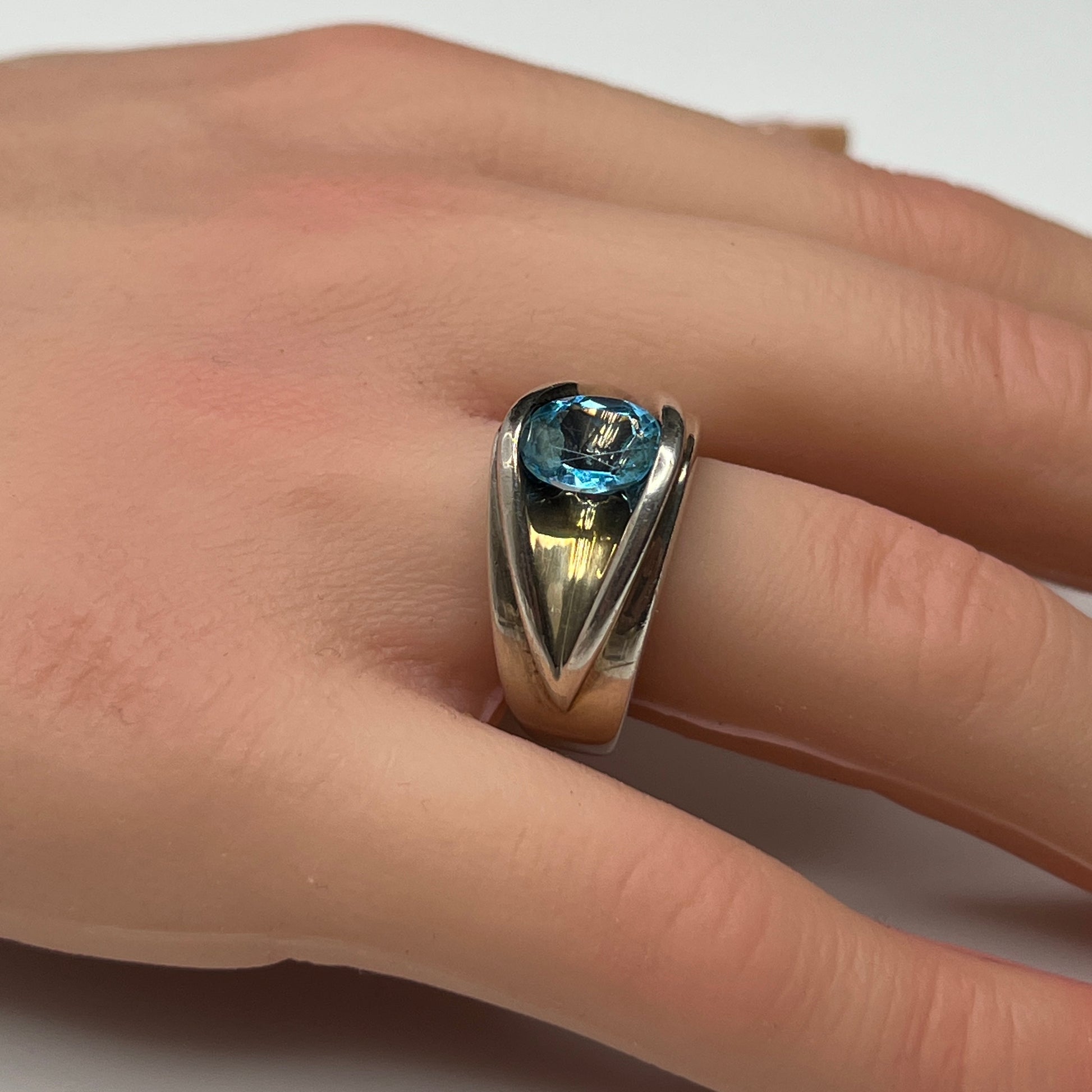 Vintage silver statement ring on hand with modernist design