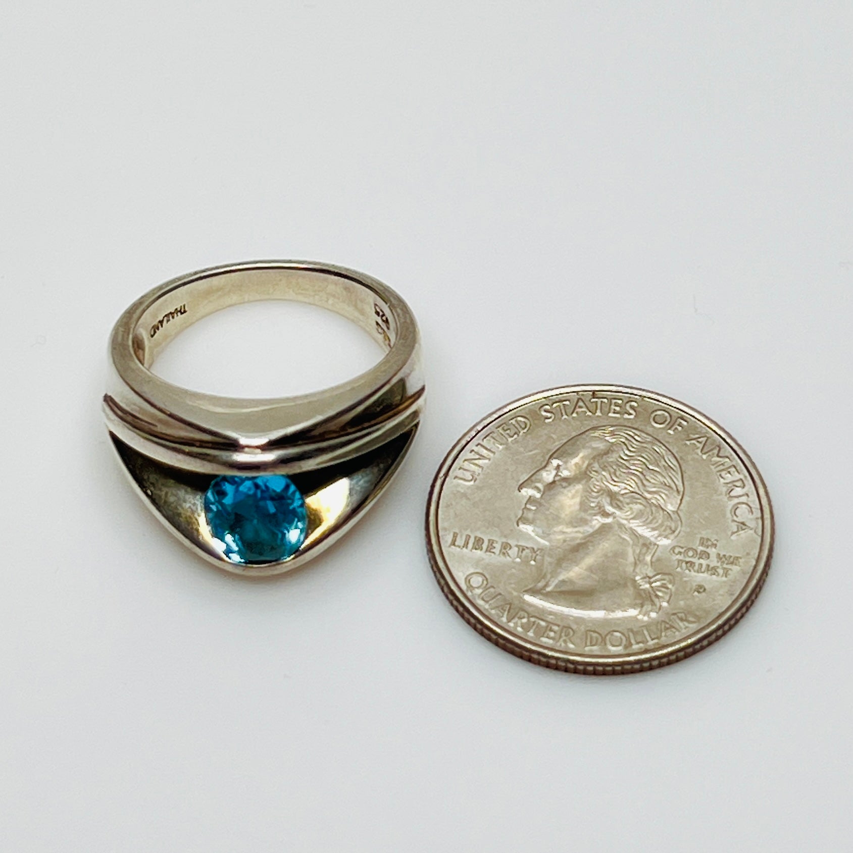Heavy sterling silver ring with oval blue topaz, front view