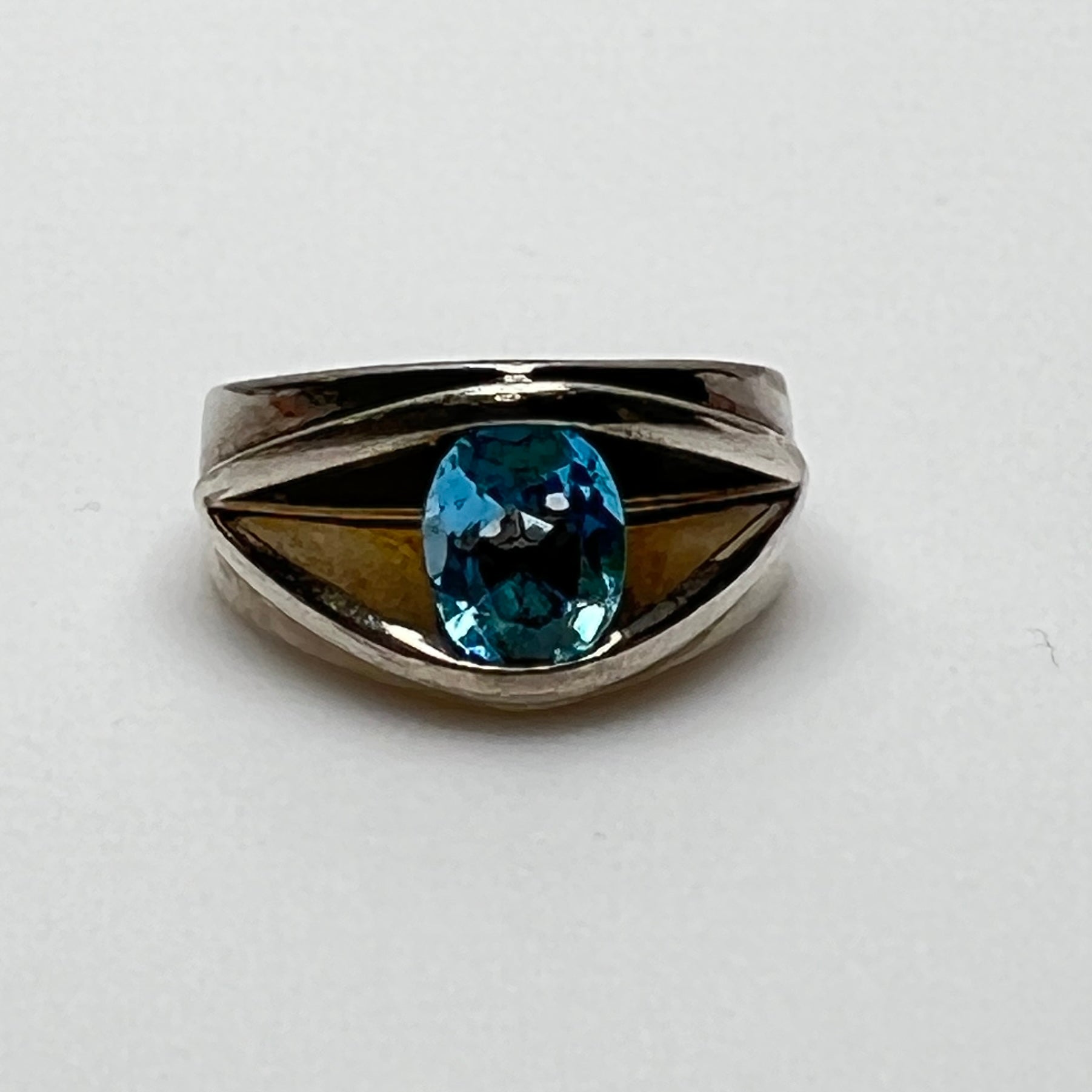 Heavy sterling silver ring with oval blue topaz, front view