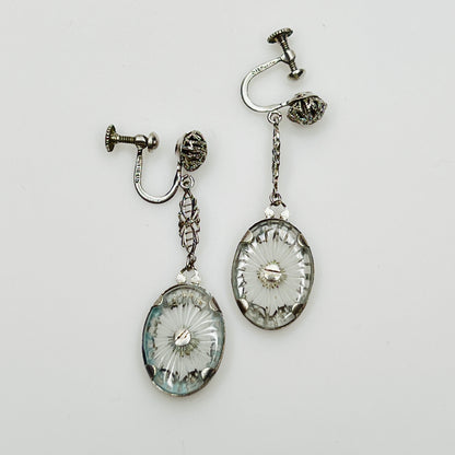 Reverse of earrings showing starburst cut camphor glass backs