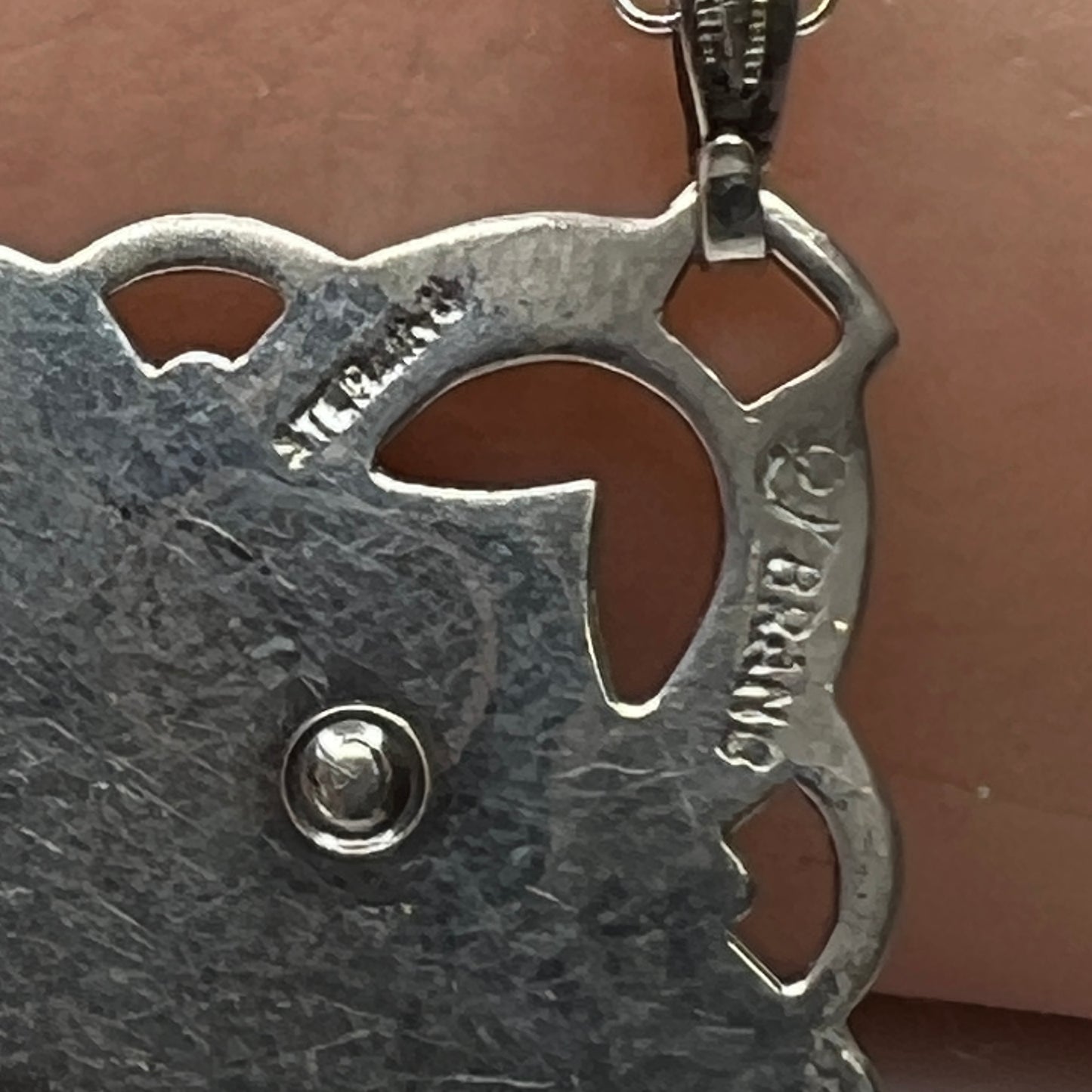Reverse side of pendant showing sterling stamp and maker’s mark