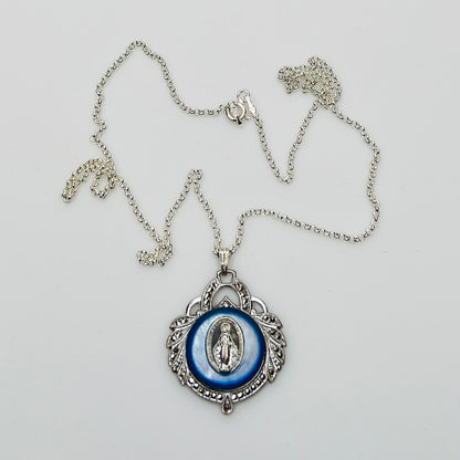 Close-up of marcasite Virgin Mary pendant with mother of pearl center