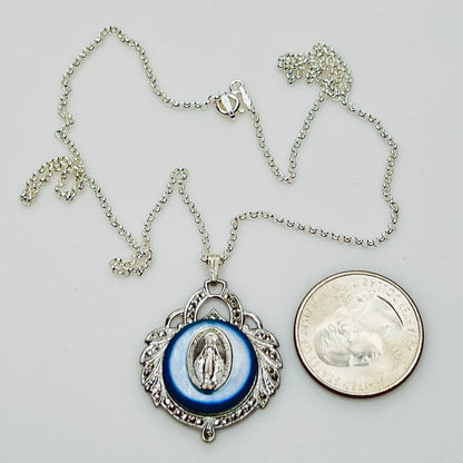 Close-up of marcasite Virgin Mary pendant with mother of pearl center