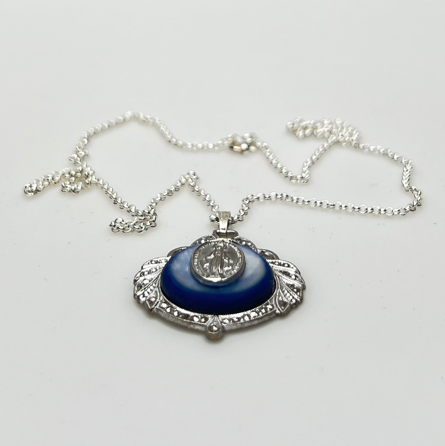 Close-up of marcasite Virgin Mary pendant with mother of pearl center