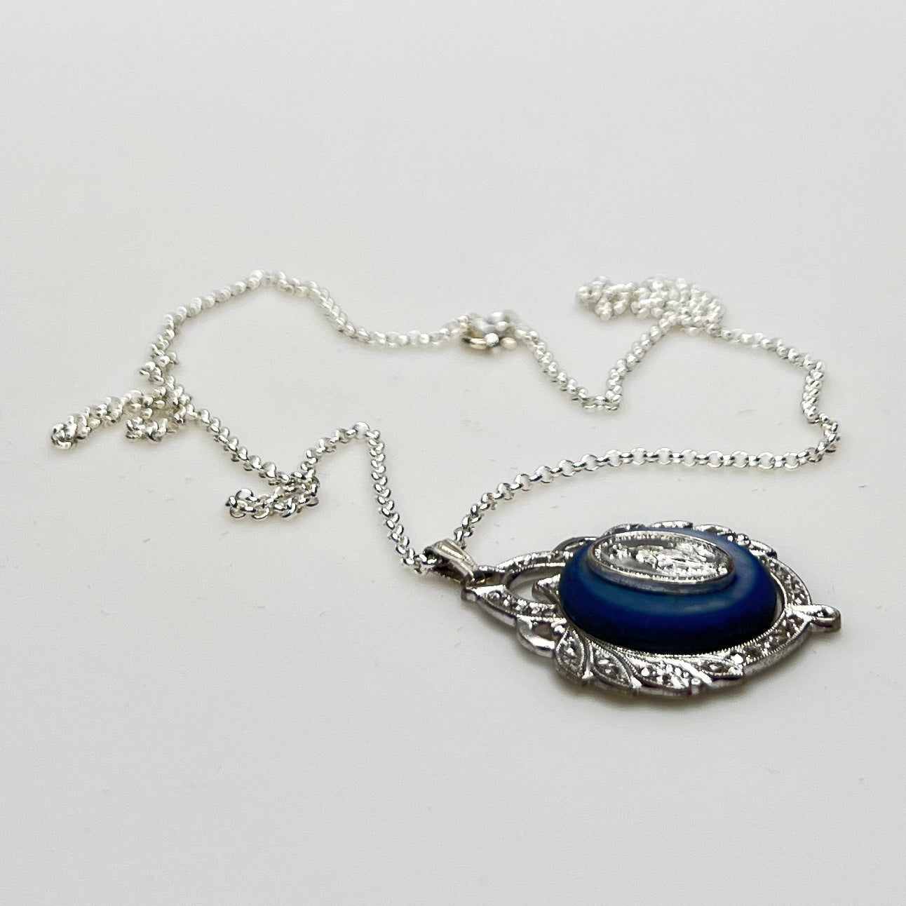 Close-up of marcasite Virgin Mary pendant with mother of pearl center