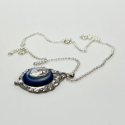 Close-up of marcasite Virgin Mary pendant with mother of pearl center