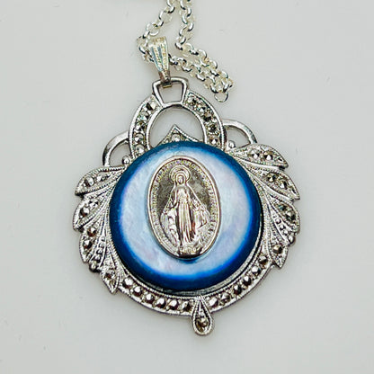 Close-up of marcasite Virgin Mary pendant with mother of pearl center
