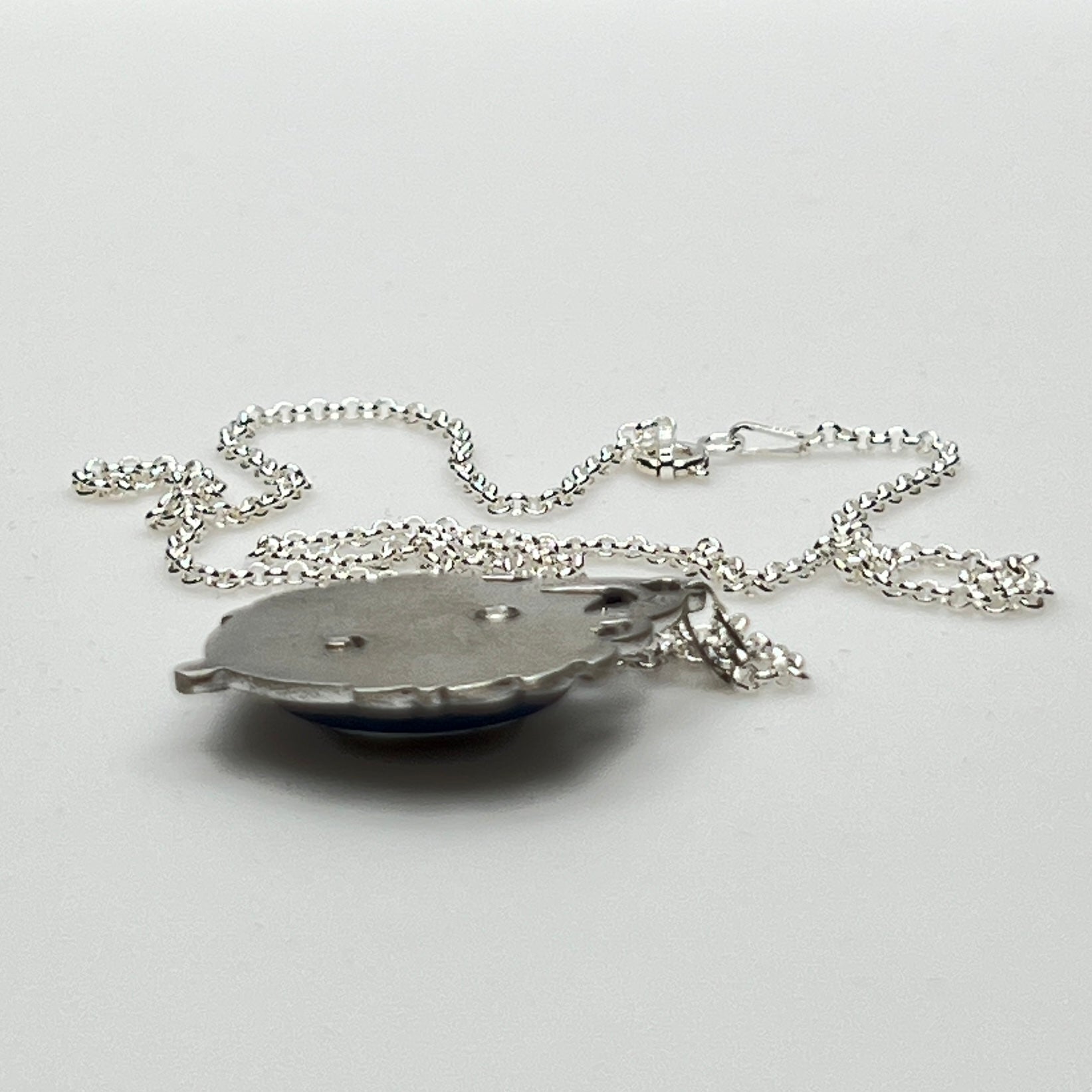 Close-up of marcasite Virgin Mary pendant with mother of pearl center