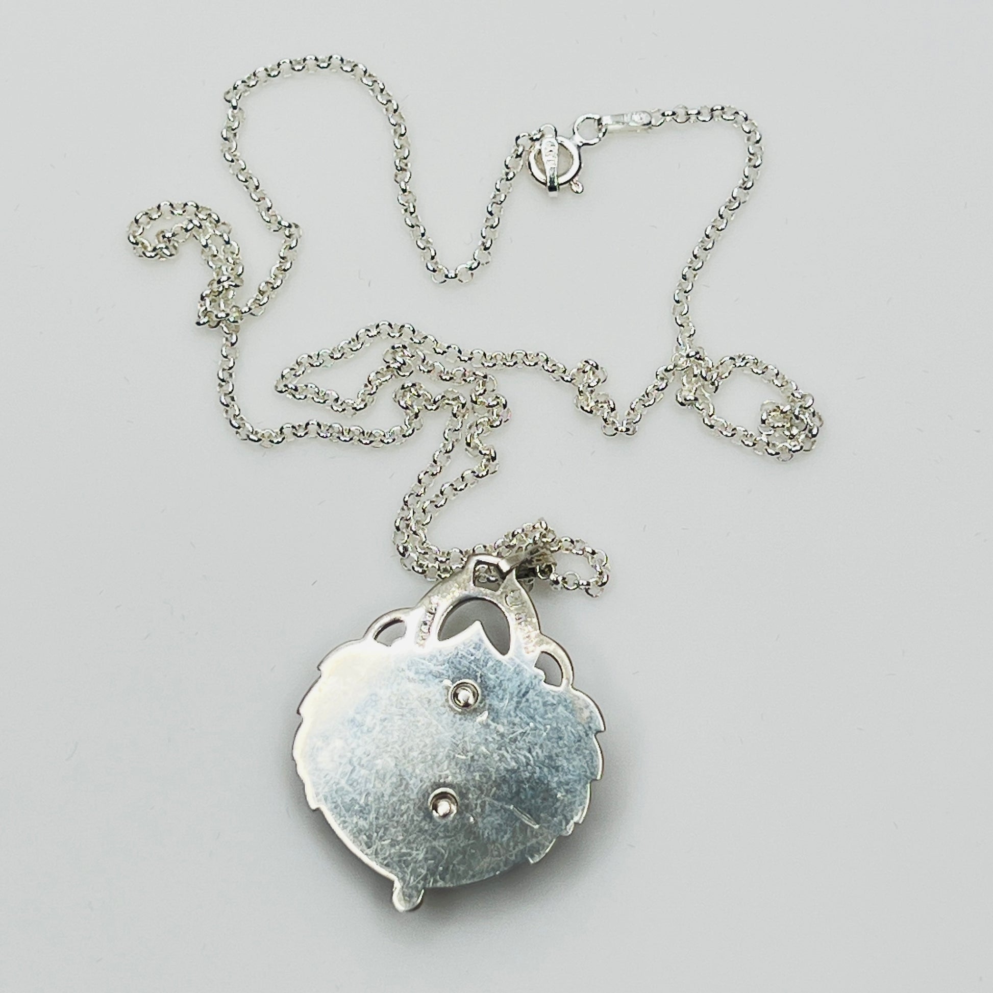 Reverse side of pendant showing sterling stamp and maker’s mark