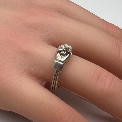 Celtic puzzle ring shown worn on hand with interlocking bands closed