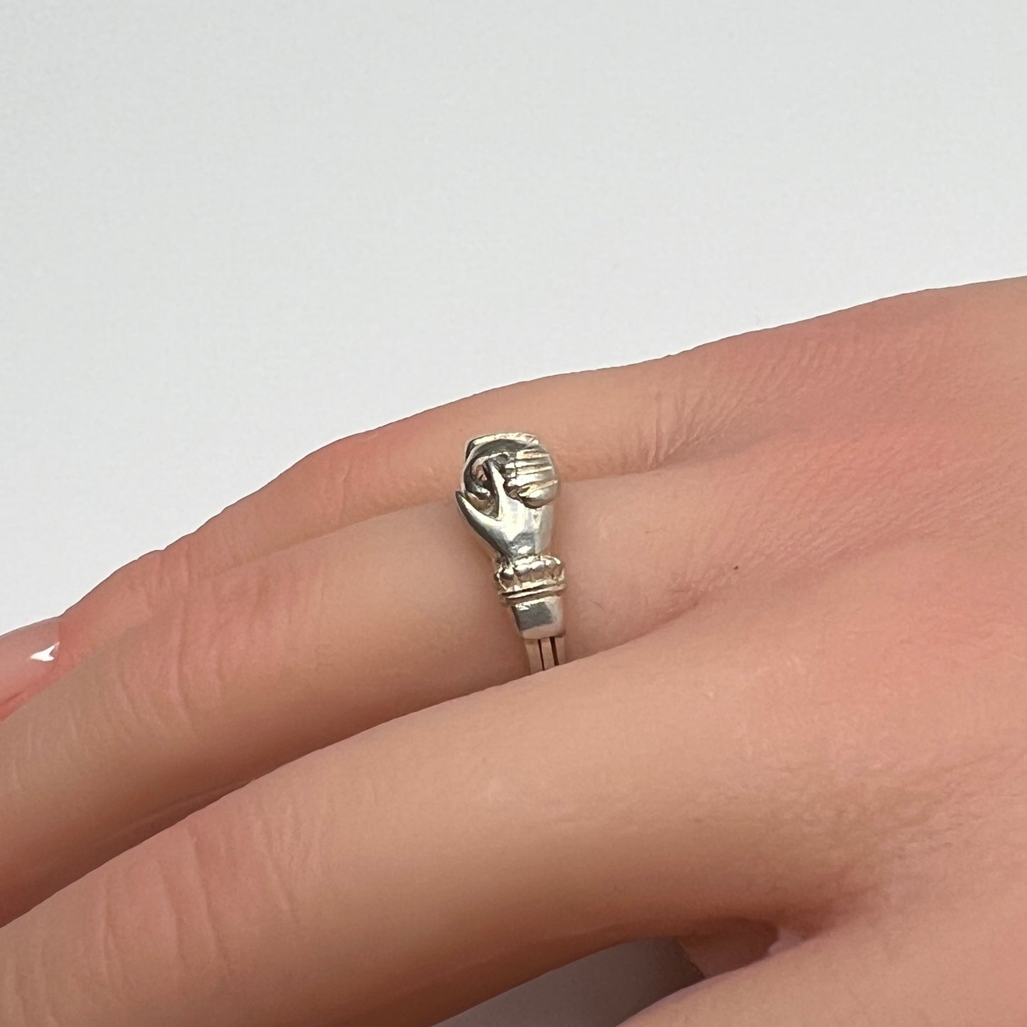 Celtic puzzle ring shown worn on hand with interlocking bands closed