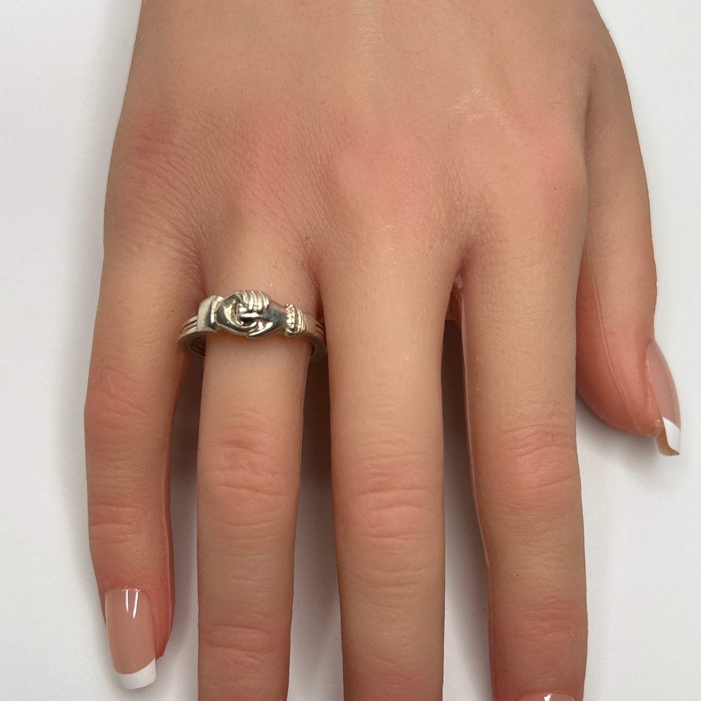 Celtic puzzle ring shown worn on hand with interlocking bands closed