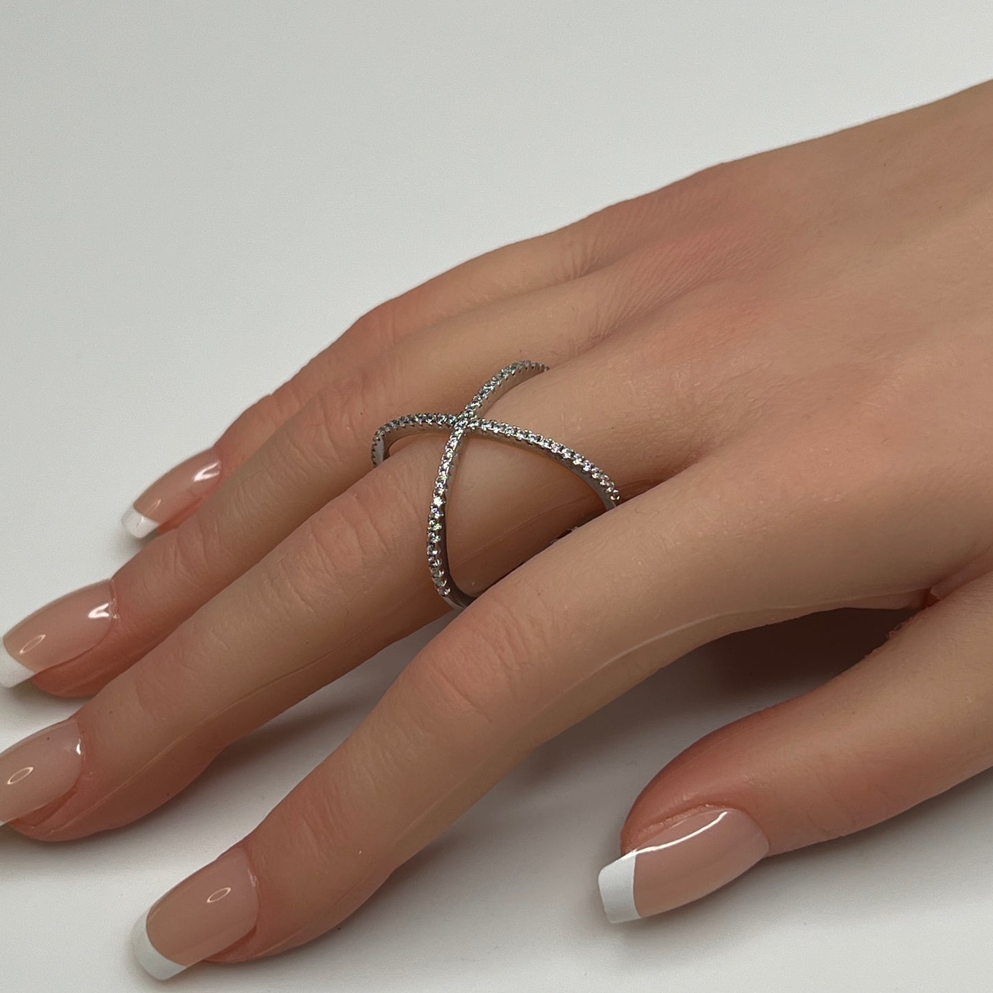 Sterling silver criss-cross ring with pavé CZs on hand, size 8
