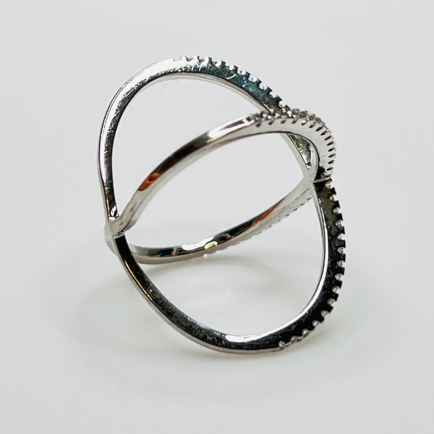 Detail of intersecting pavé CZ bands on silver ring