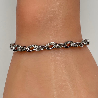 Sterling silver diamond link bracelet worn on wrist
