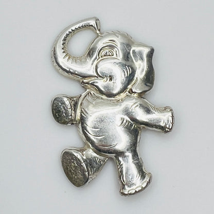 Sterling silver brooch shaped like a walking elephant with raised trunk and rounded limbs