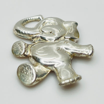 Sterling silver brooch shaped like a walking elephant with raised trunk and rounded limbs