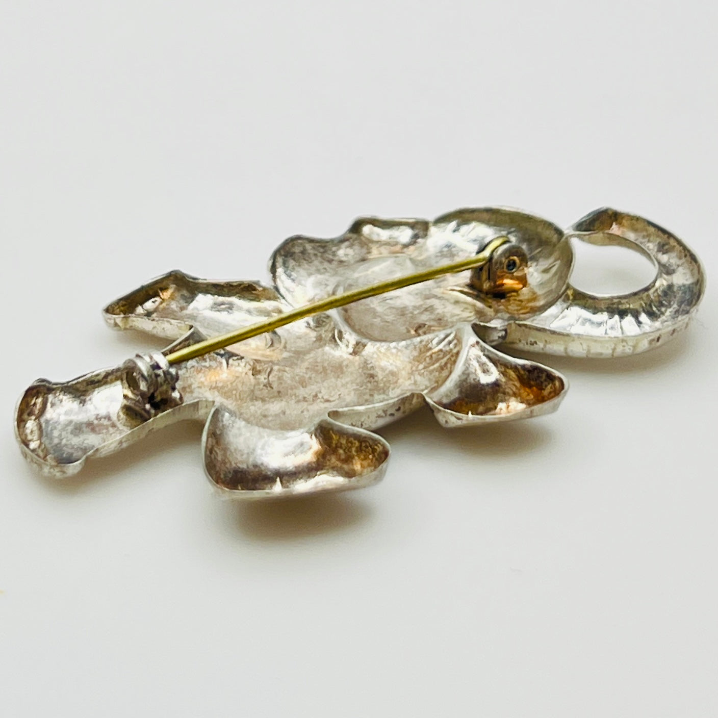 Back view of sterling silver elephant brooch showing rollover clasp and vintage patina