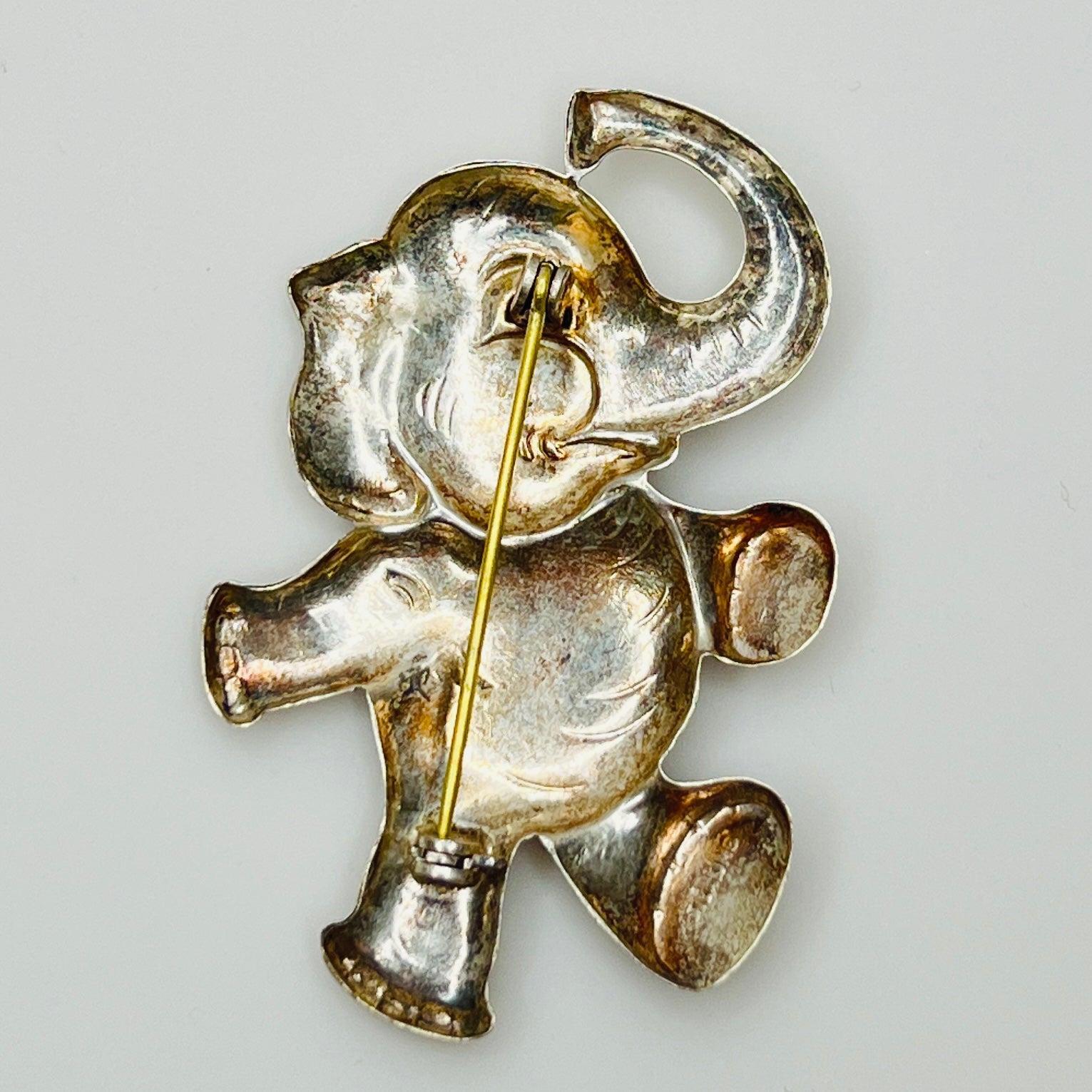 Back view of sterling silver elephant brooch showing rollover clasp and vintage patina