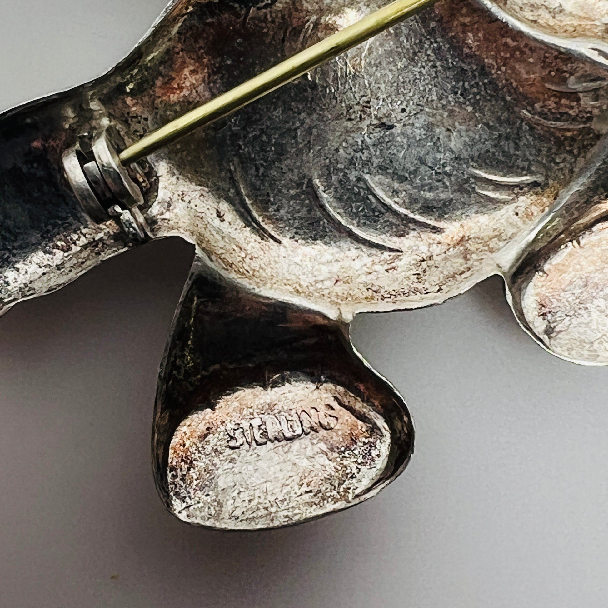 Close-up of sterling hallmark on reverse of vintage elephant brooch