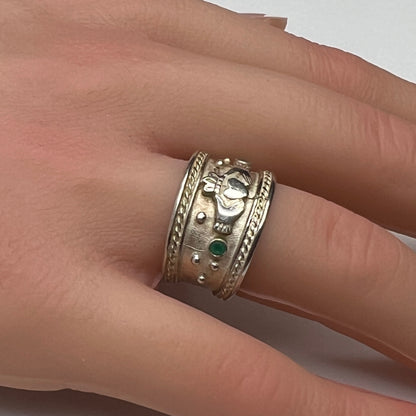 Wide vintage Irish Claddagh ring on hand, silver with patina