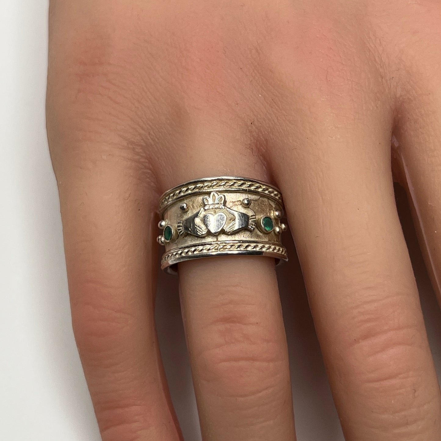 Wide vintage Irish Claddagh ring on hand, silver with patina