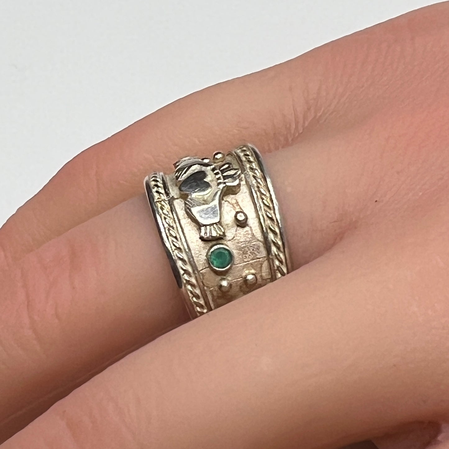 Wide vintage Irish Claddagh ring on hand, silver with patina
