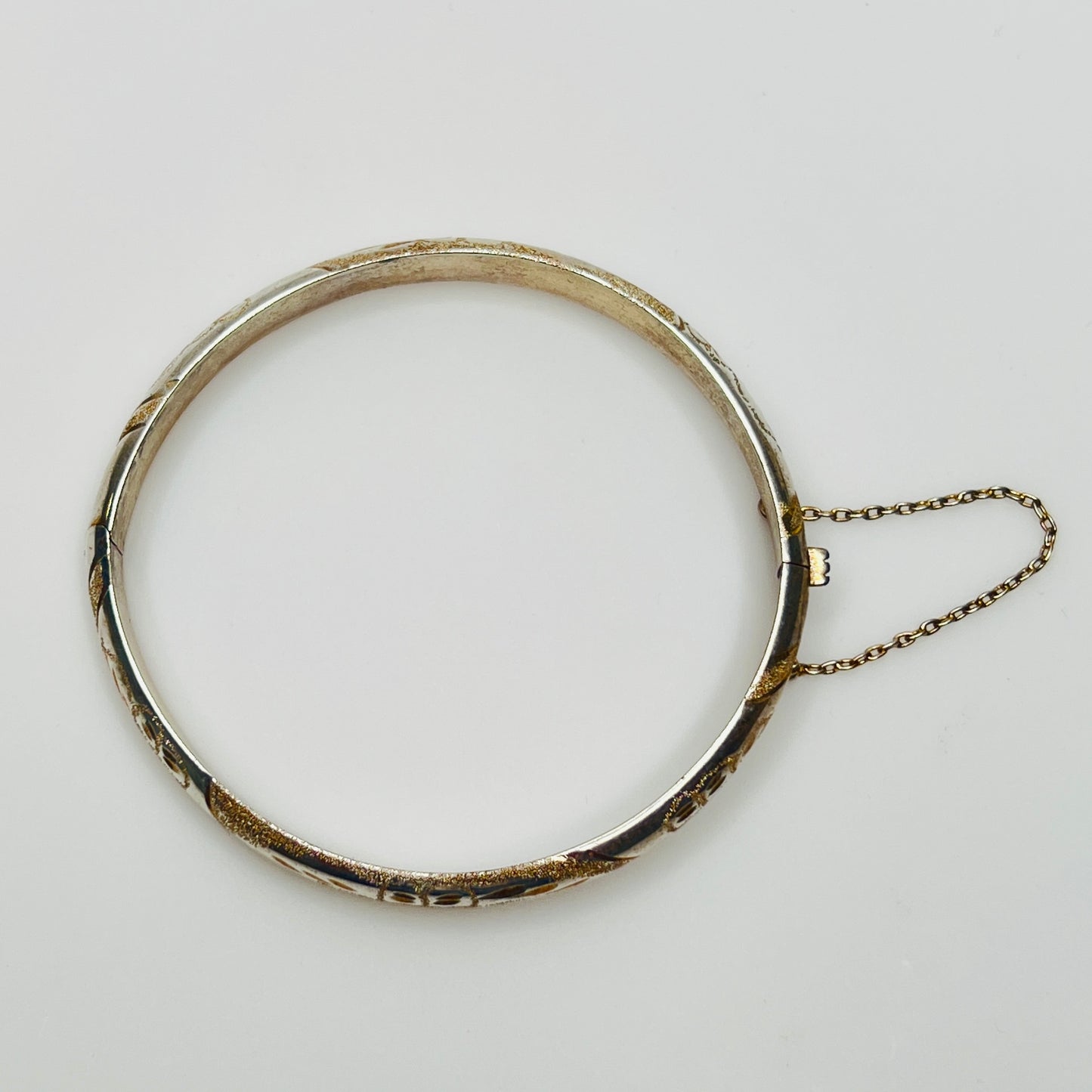 Vintage sterling silver hinged bangle with etched floral scroll design