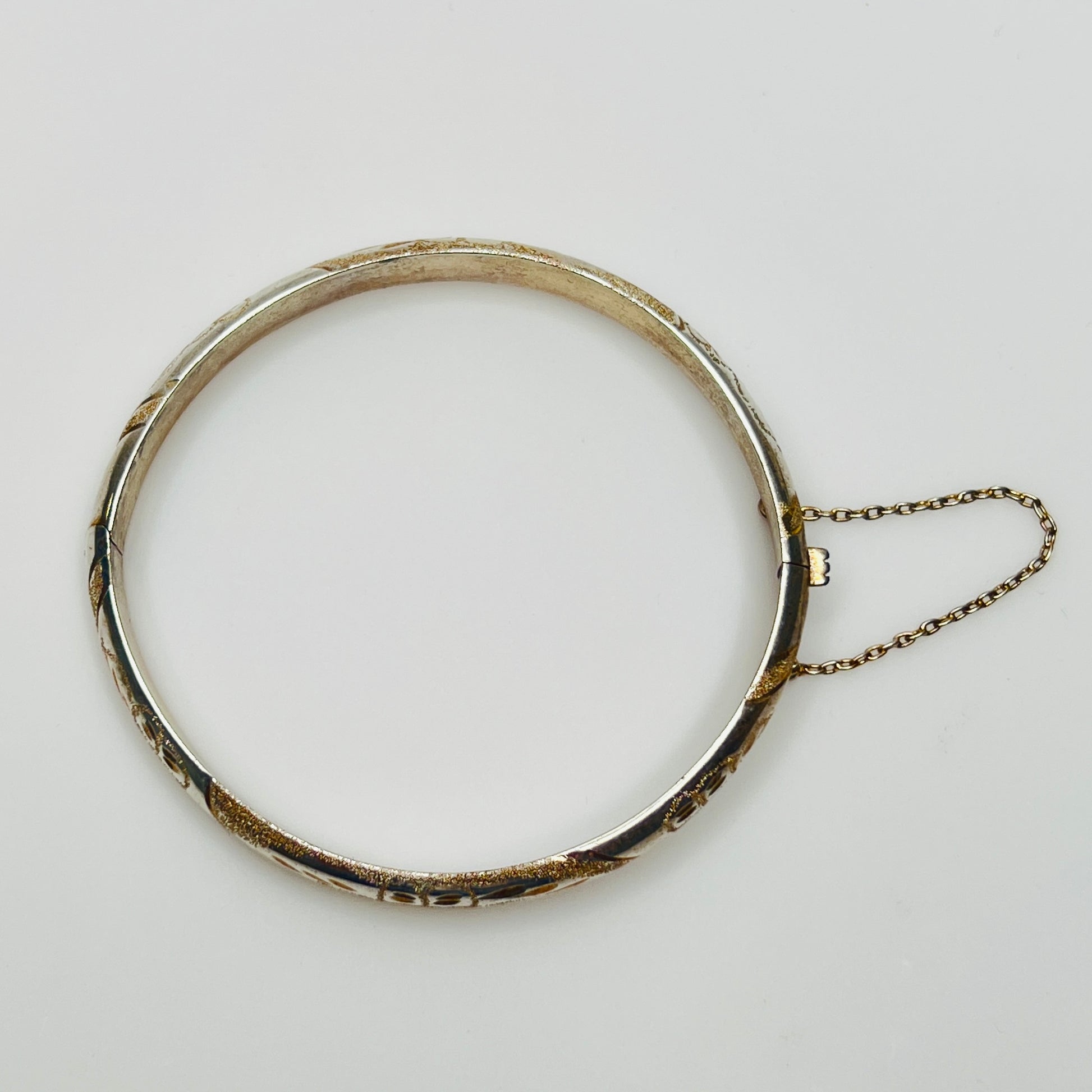 Vintage sterling silver hinged bangle with etched floral scroll design