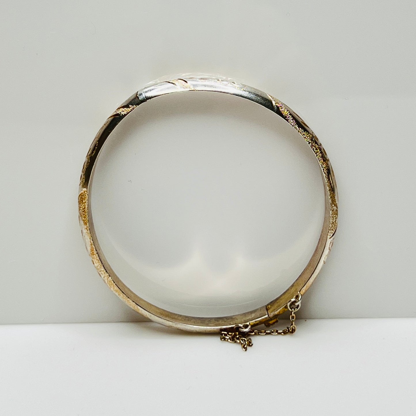 Vintage sterling silver hinged bangle with etched floral scroll design