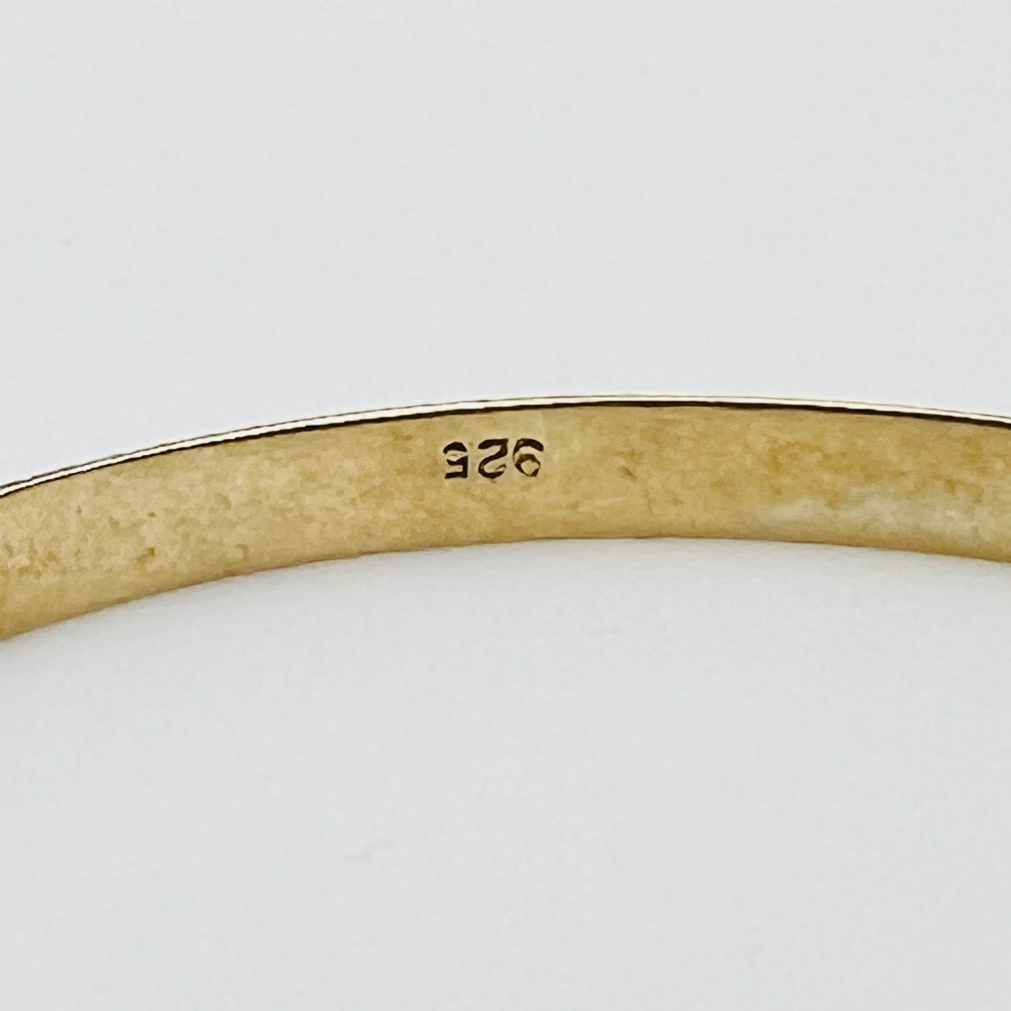 Inside view showing “925” stamp on gold-tone sterling bracelet