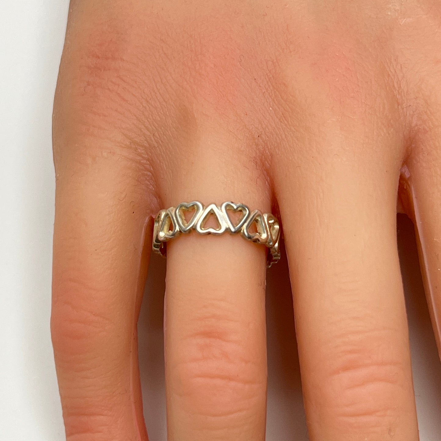 Close-up of silver open-heart design ring with 5mm band