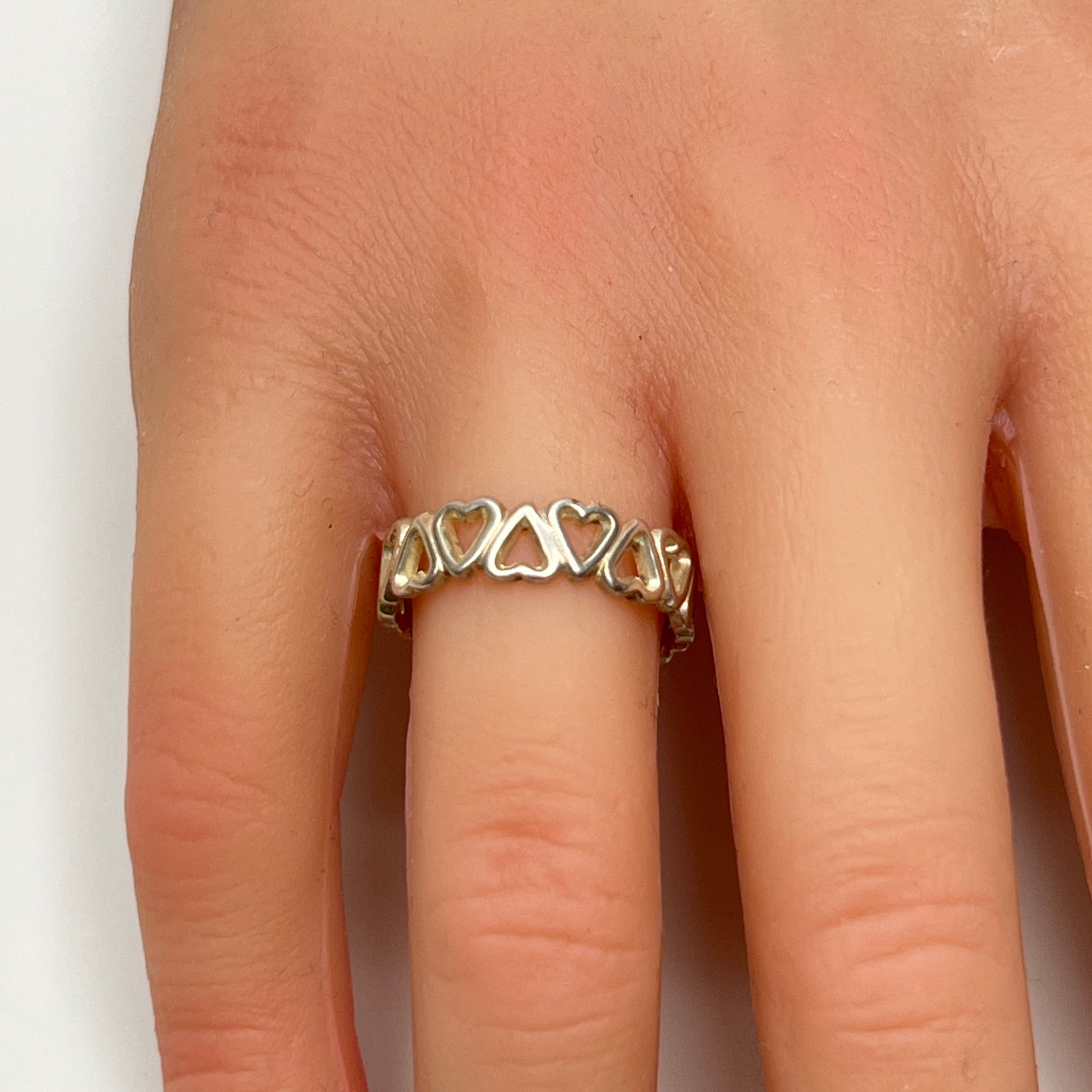 Close-up of silver open-heart design ring with 5mm band